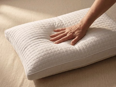 Hand pressing on pillow